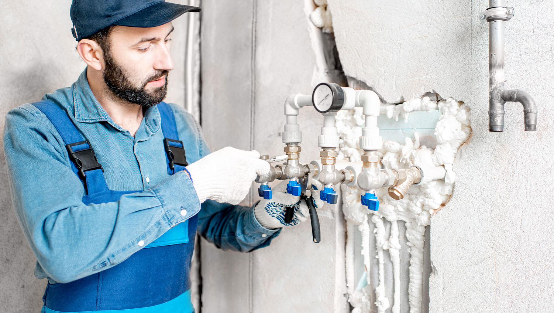 Technician checking a water heating manifold and valves